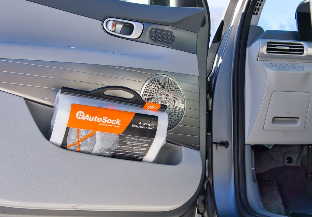 AutoSock product packaging conveniently stored in side door of a car