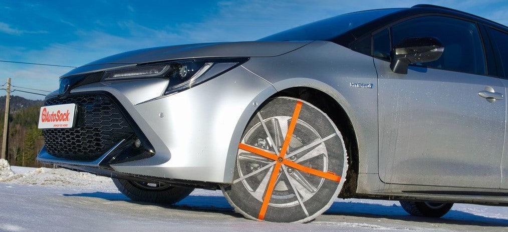 AutoSock snow socks installed on front wheels of passenger car - available for New Zealand